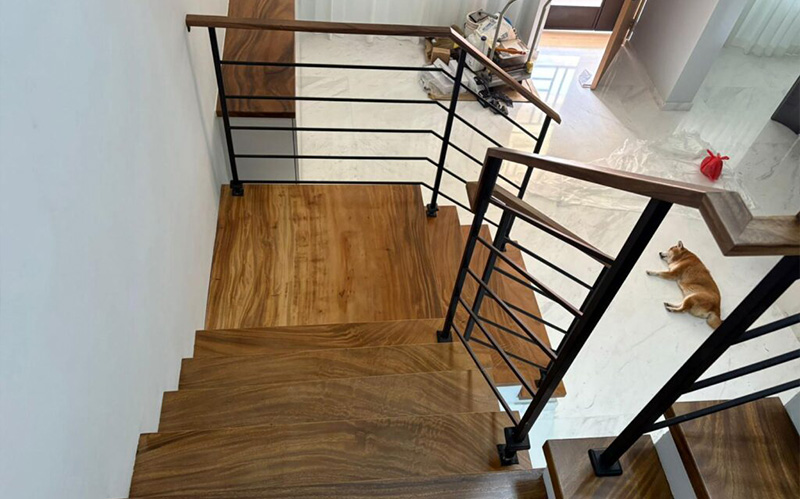 Overhead view of a solid wood staircase and matching handrail